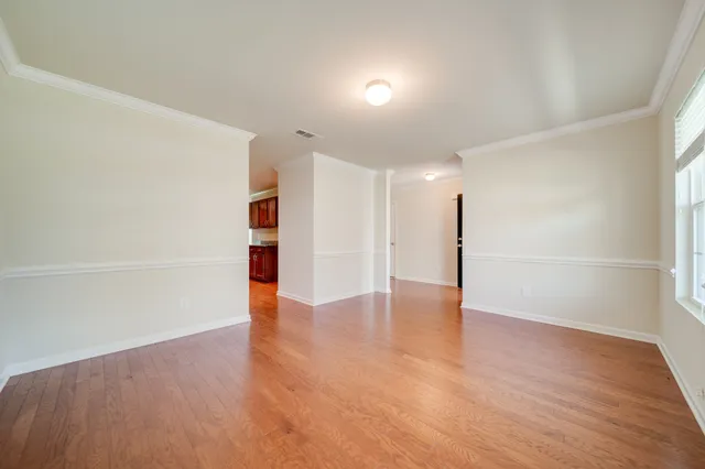 a large kitchen with stainless steel appliances granite countertop wooden cabinets a stove a sink and dishwasher