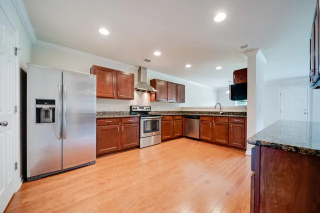 a kitchen with stainless steel appliances granite countertop a stove sink and cabinets