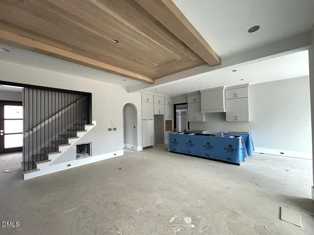 a view of an empty room with closet and a window