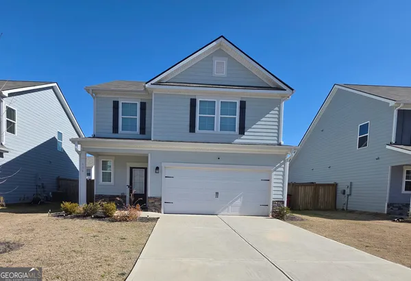 a front view of a house with a yard