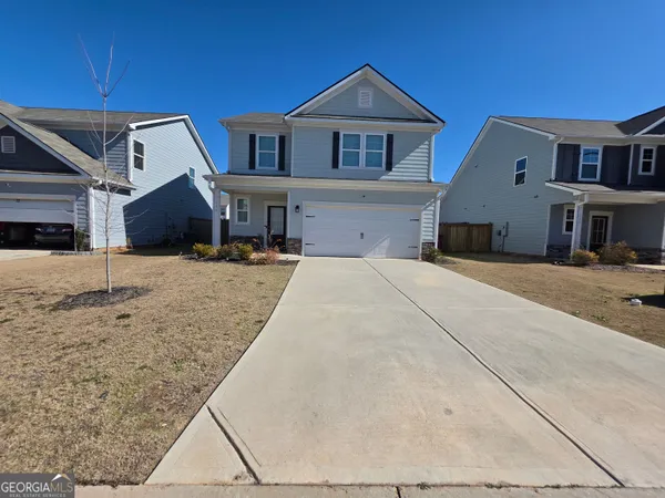 a front view of a house with a yard