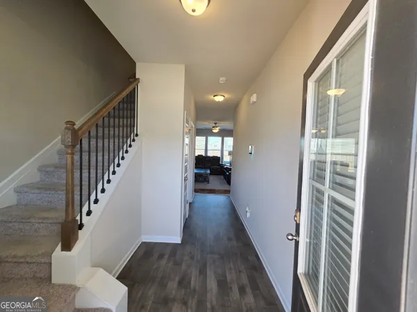 a view of entryway and hall with wooden floor