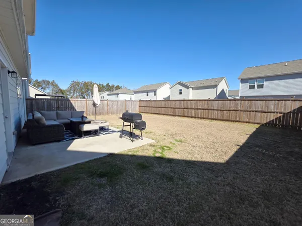 a view of a backyard with sitting area