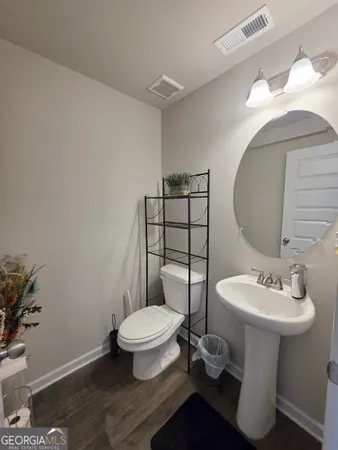 a bathroom with a sink toilet and a mirror