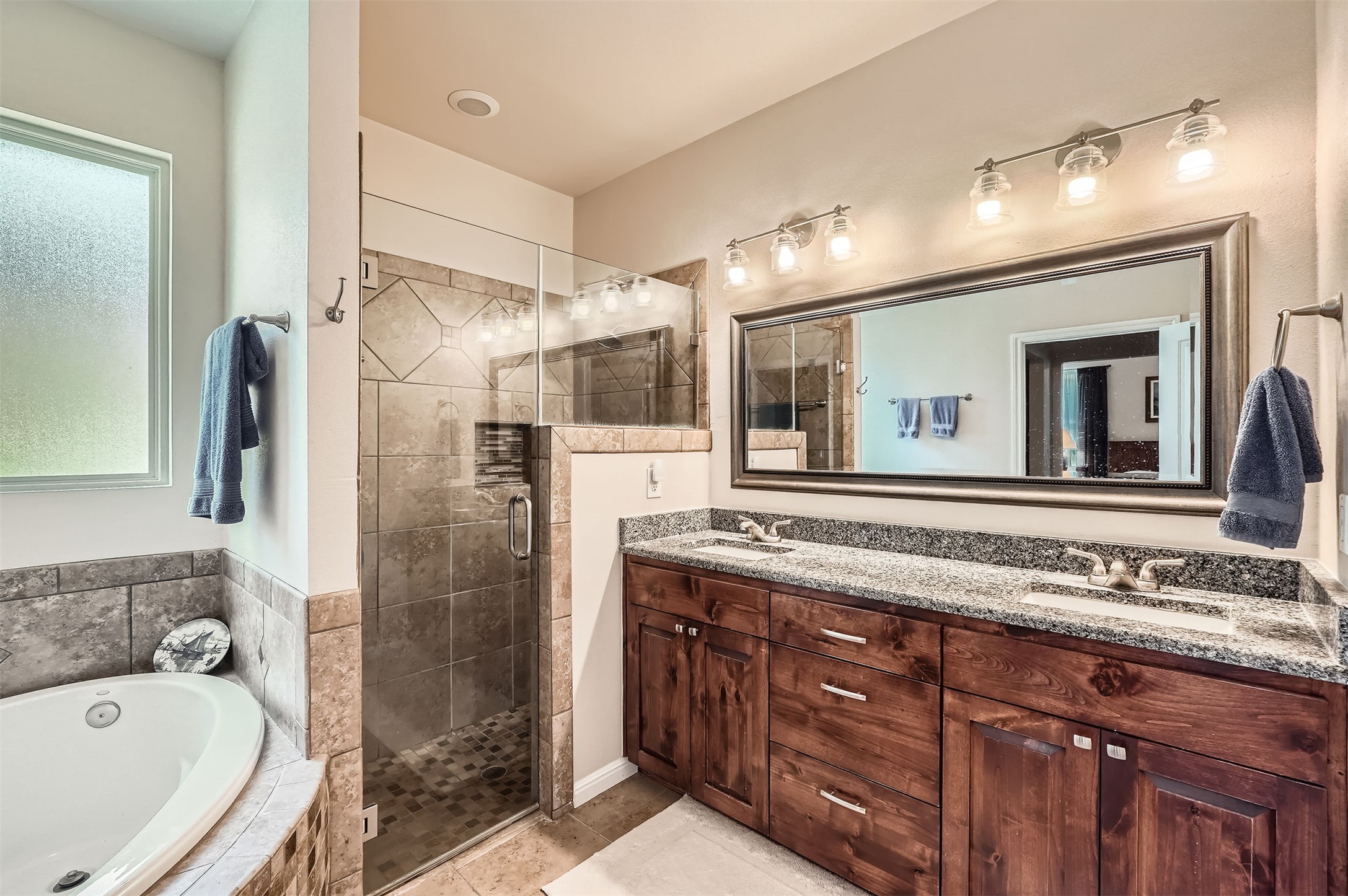 5501 Hitching Post Lago Vista, TX 78645 - Photo 17 of 26 a bathroom with a tub sink and mirror