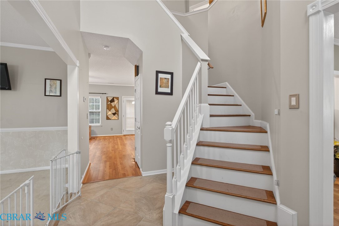 116 Old Field Road Williamsburg, VA 23188 - Photo 3 of 27 Stairs with crown molding and wood finished floors