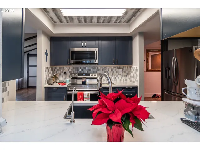 a living room with stainless steel appliances kitchen island granite countertop furniture and a kitchen view