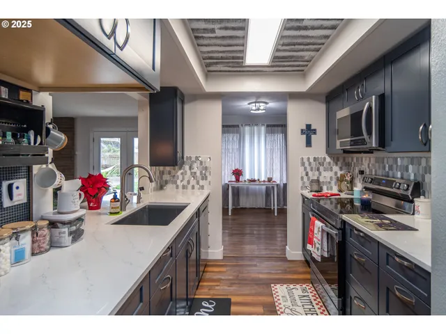 a kitchen that has a sink and a stove