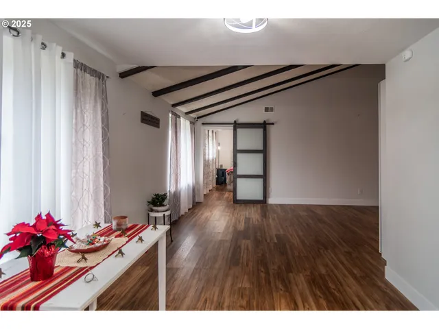 a view of a hallway and wooden floor