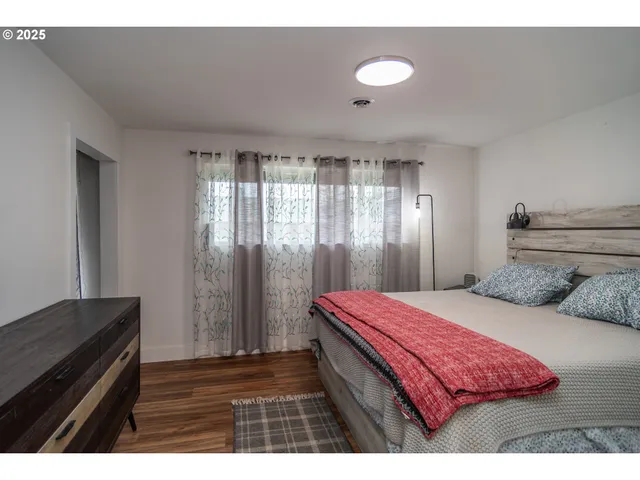 a bedroom with a bed and a dresser