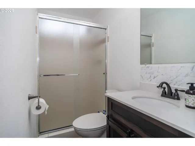 a bathroom with a sink toilet and mirror