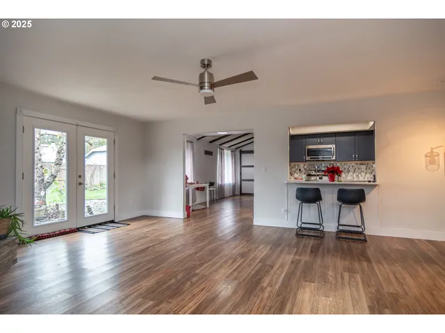 a open kitchen with dining table and wooden floor