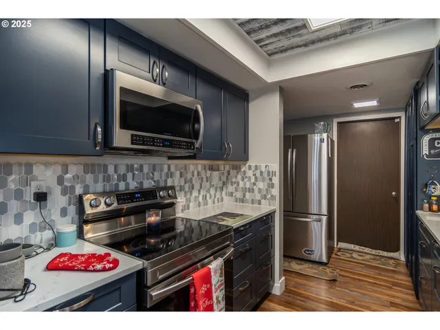 a kitchen with a refrigerator a stove and a microwave