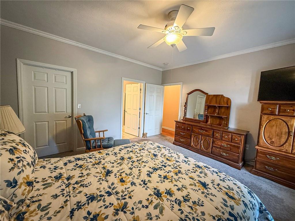 2113 Winchester Court Renfrew, PA 16053 - Photo 23 of 45 a bedroom with a bed dresser and a flat tv screen