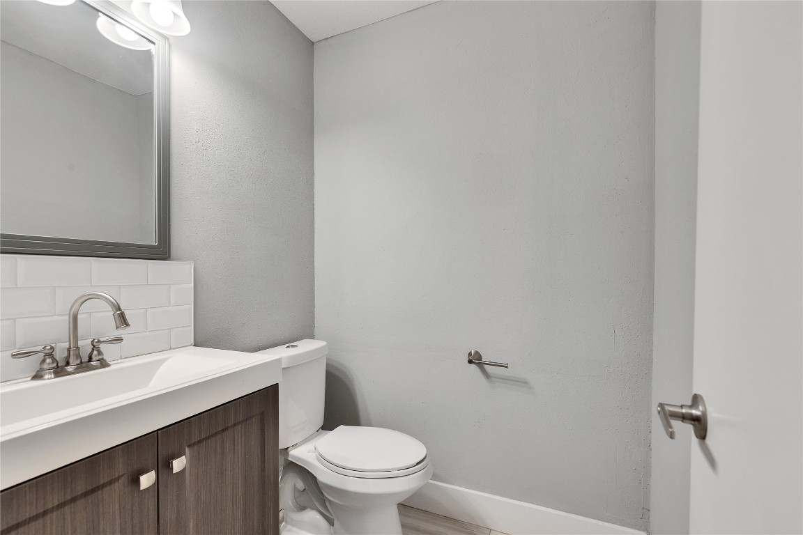4721 Blueberry Trail, Unit A Austin, TX 78723 - Photo 18 of 23 a bathroom with a sink mirror vanity and toilet