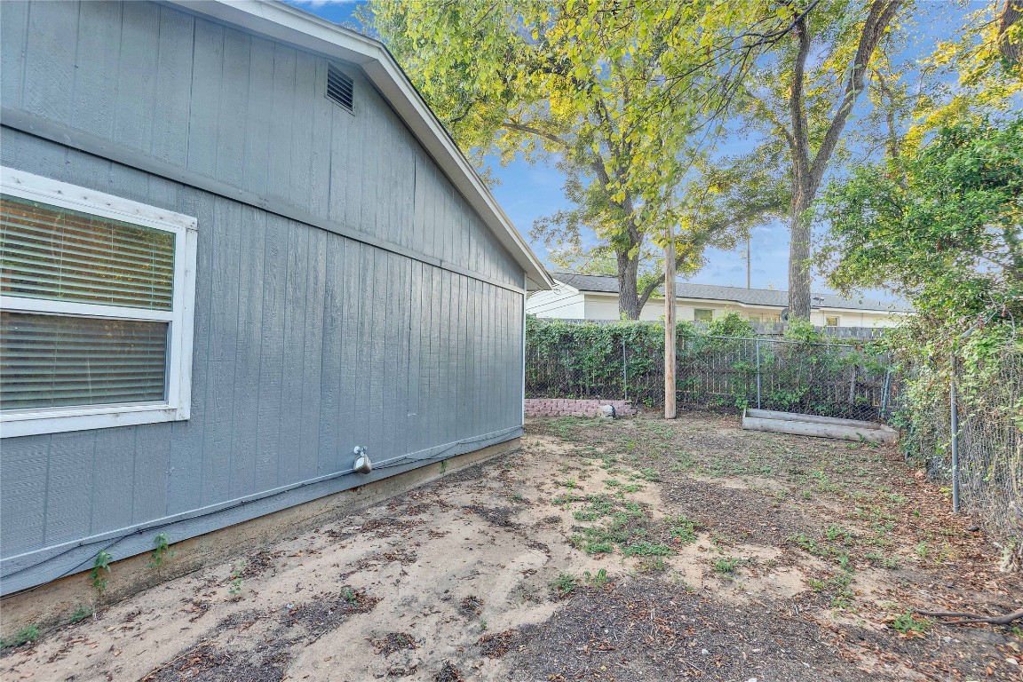 4721 Blueberry Trail, Unit A Austin, TX 78723 - Photo 23 of 23 a view of a backyard with large trees and wooden fence