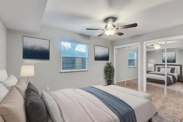 a bedroom with a large bed and a chandelier