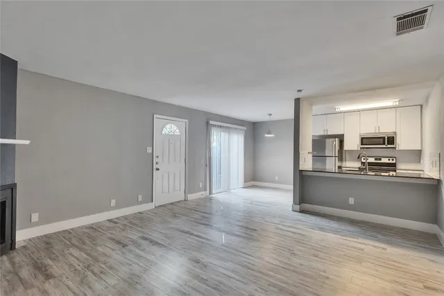 a view of kitchen and wooden floor