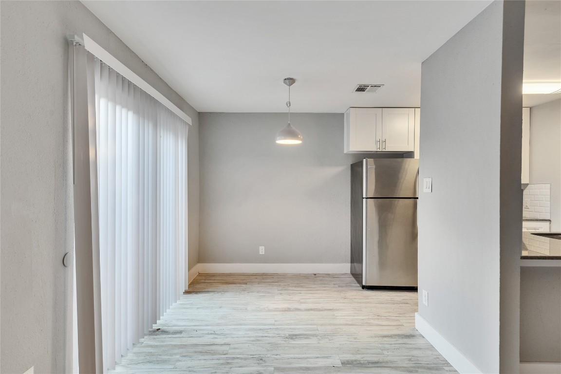4721 Blueberry Trail, Unit A Austin, TX 78723 - Photo 7 of 23 a view of empty room with wooden floor and kitchen