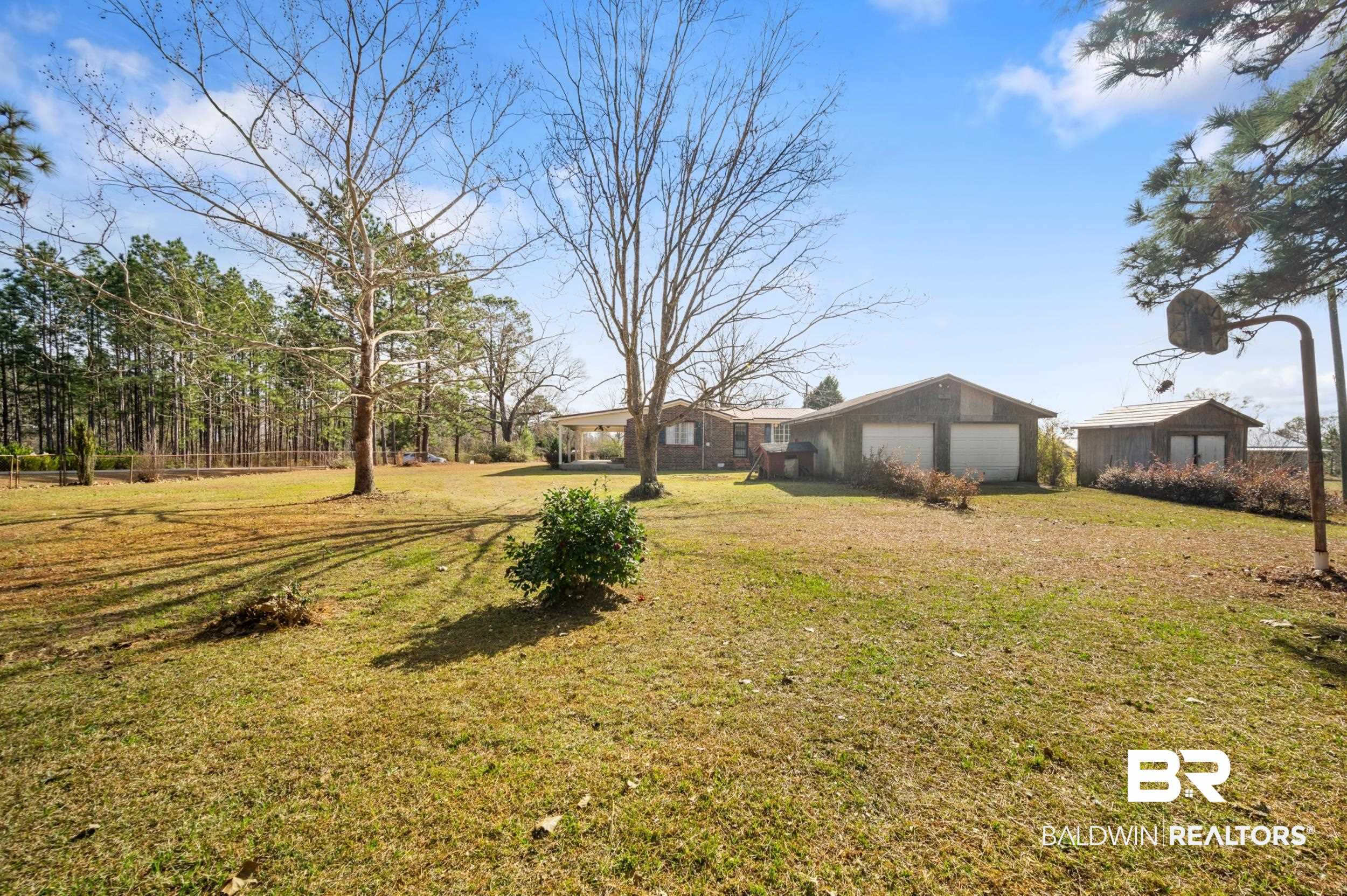 57623 Mary Hadley Road Perdido, AL 36562 - Photo 25 of 34 View of green lawn with a garage