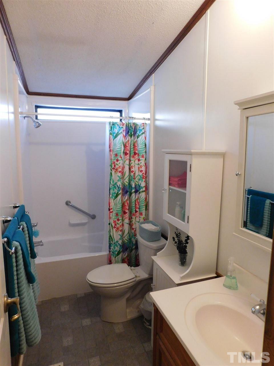9402 Hampton Road Rougemont, NC 27572 - Photo 12 of 18 a bathroom with a sink toilet and shower