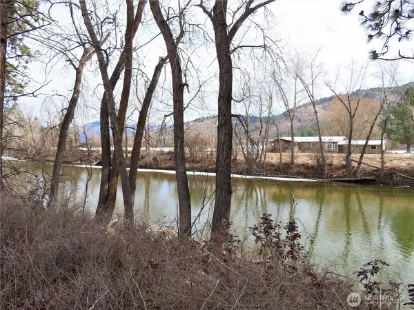 a lake view with boat and trees in the background