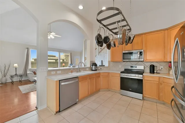 a kitchen with stainless steel appliances granite countertop a sink and a stove