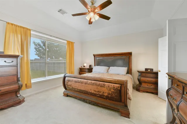 a bedroom with a bed and a tv