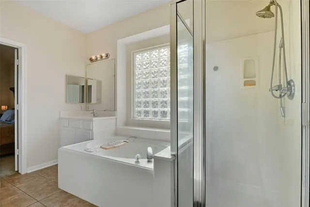 a bathroom with a bathtub sink and mirror