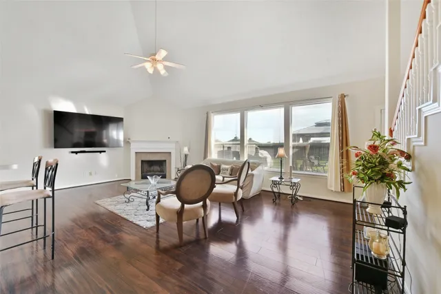 a living room with furniture a fireplace and a flat screen tv