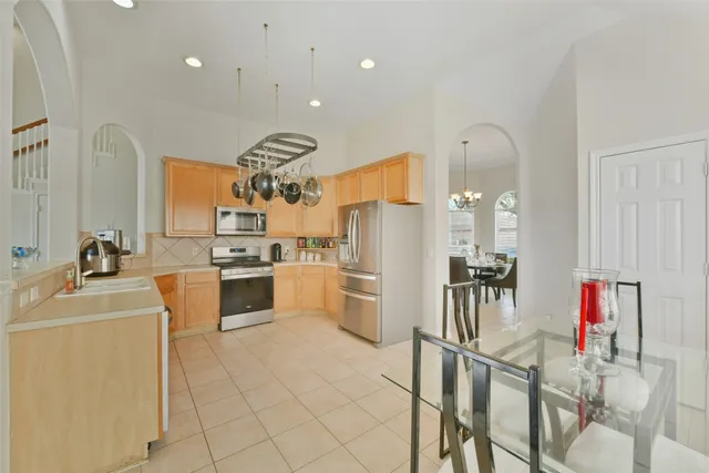 a kitchen with a table and chairs