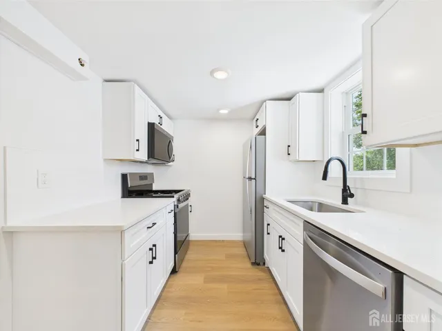 a bathroom with a shower sink vanity and toilet