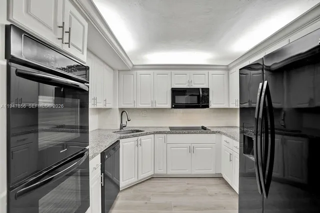a kitchen with a sink stainless steel appliances and cabinets