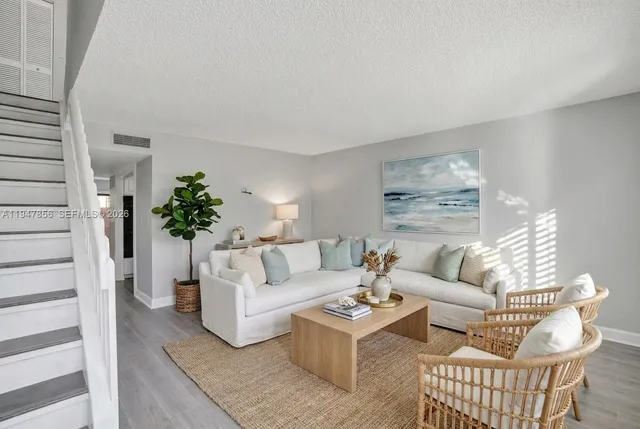 a living room with furniture potted plant and a window