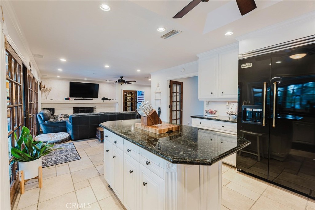 25261 Avenida Rondel Valencia, CA 91355 - Photo 11 of 68 a kitchen with stainless steel appliances granite countertop a sink a stove and cabinets