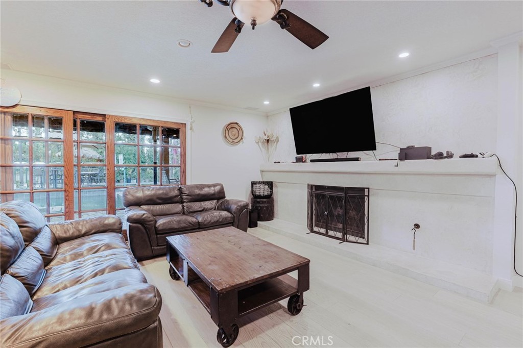 25261 Avenida Rondel Valencia, CA 91355 - Photo 12 of 68 a living room with furniture a flat screen tv and a fireplace