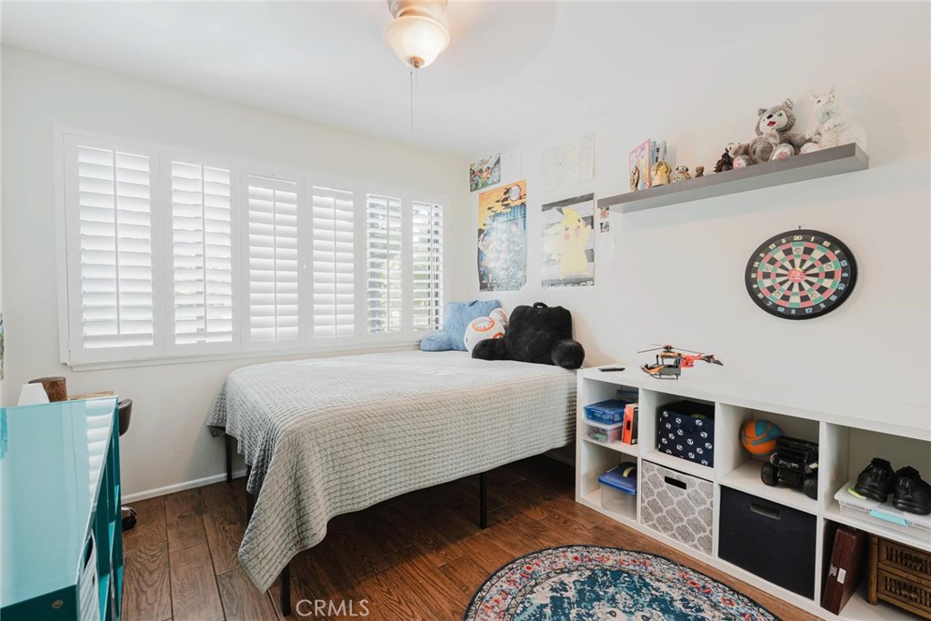25261 Avenida Rondel Valencia, CA 91355 - Photo 25 of 68 a bedroom with a bed and a bookshelf
