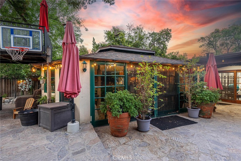 25261 Avenida Rondel Valencia, CA 91355 - Photo 36 of 68 a view of a patio with table and chairs potted plants