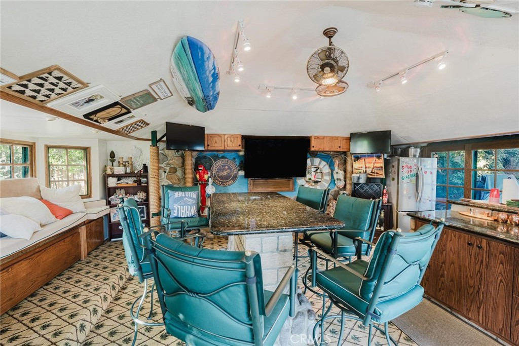 25261 Avenida Rondel Valencia, CA 91355 - Photo 37 of 68 a dining room with furniture and wooden floor