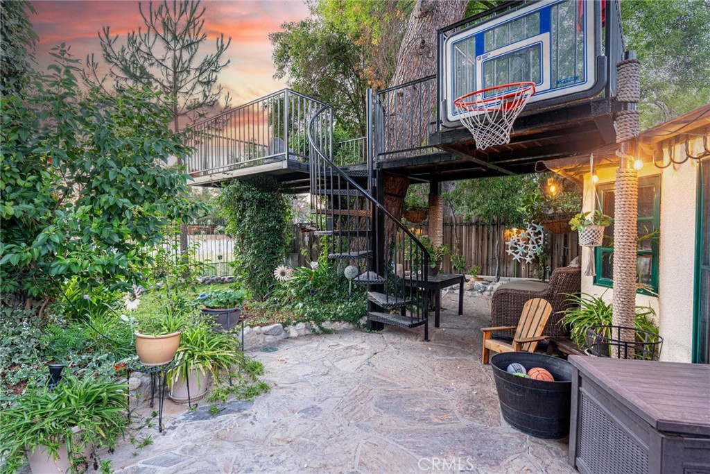 25261 Avenida Rondel Valencia, CA 91355 - Photo 39 of 68 a view of a patio with table and chairs and potted plants