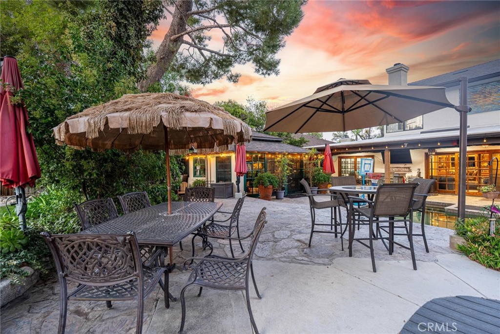 25261 Avenida Rondel Valencia, CA 91355 - Photo 43 of 68 a view of patio with chairs and table under an umbrella