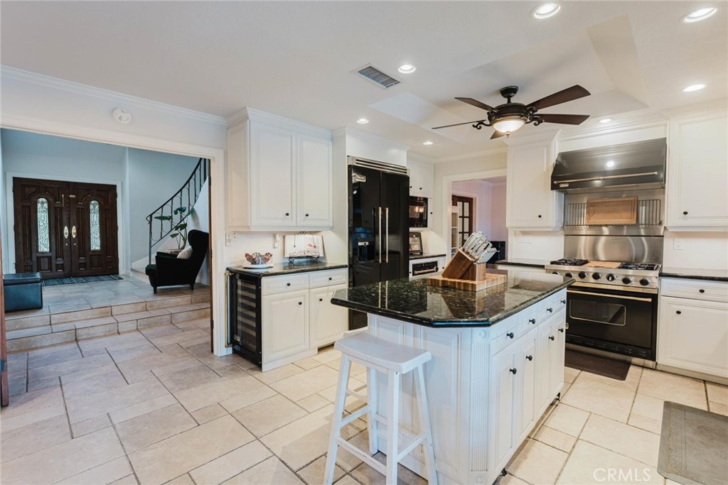 25261 Avenida Rondel Valencia, CA 91355 - Photo 8 of 68 a kitchen with stainless steel appliances kitchen island granite countertop a sink and cabinets
