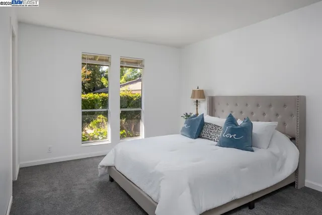 a bedroom with a bed and window