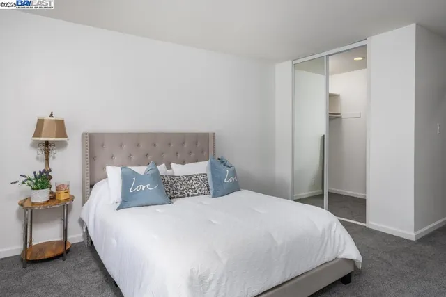 a bedroom with a bed and a table