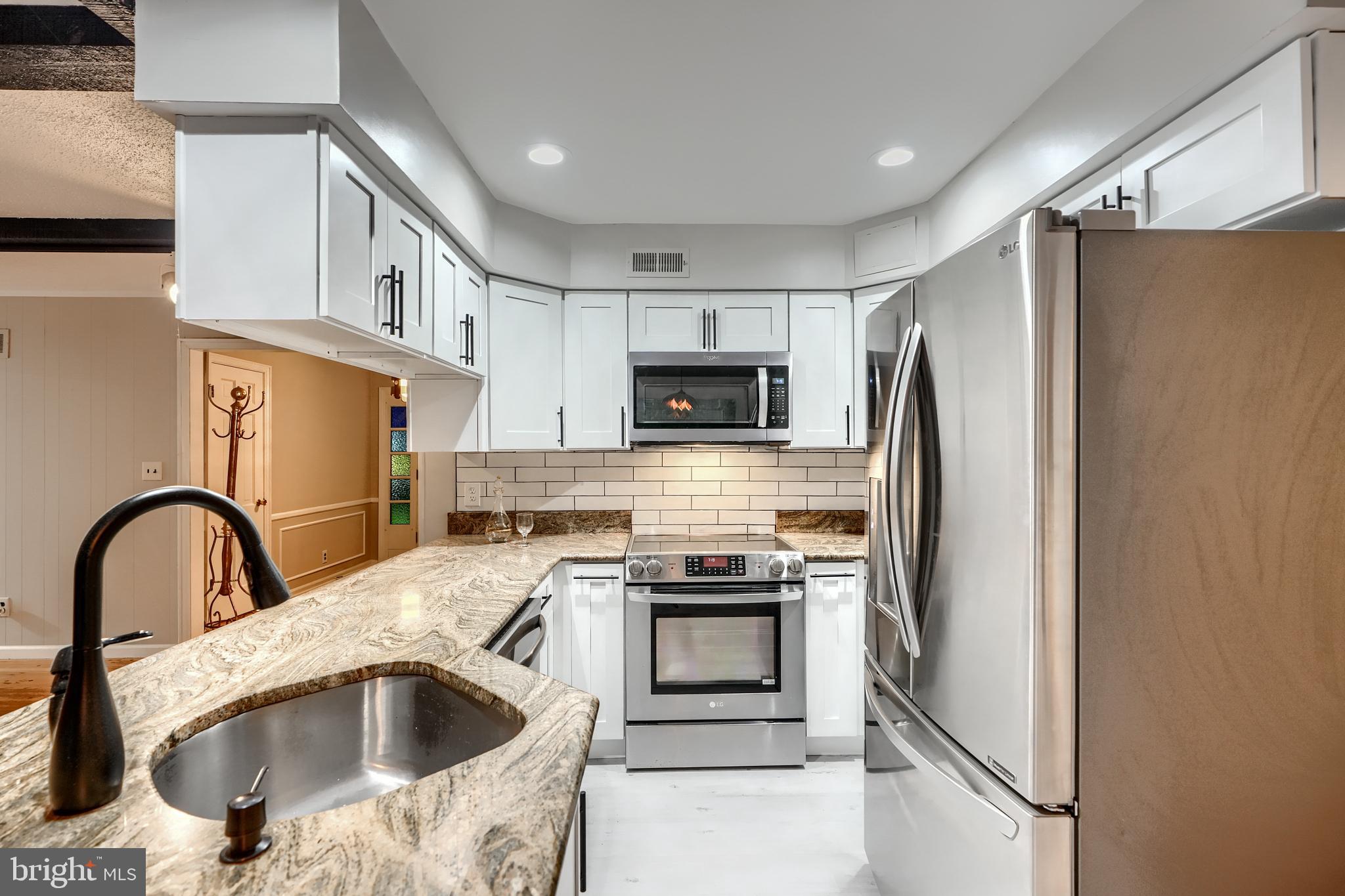 1012 Valewood Road Towson, MD 21286 - Photo 20 of 48 a kitchen with a sink a refrigerator and a stove top oven