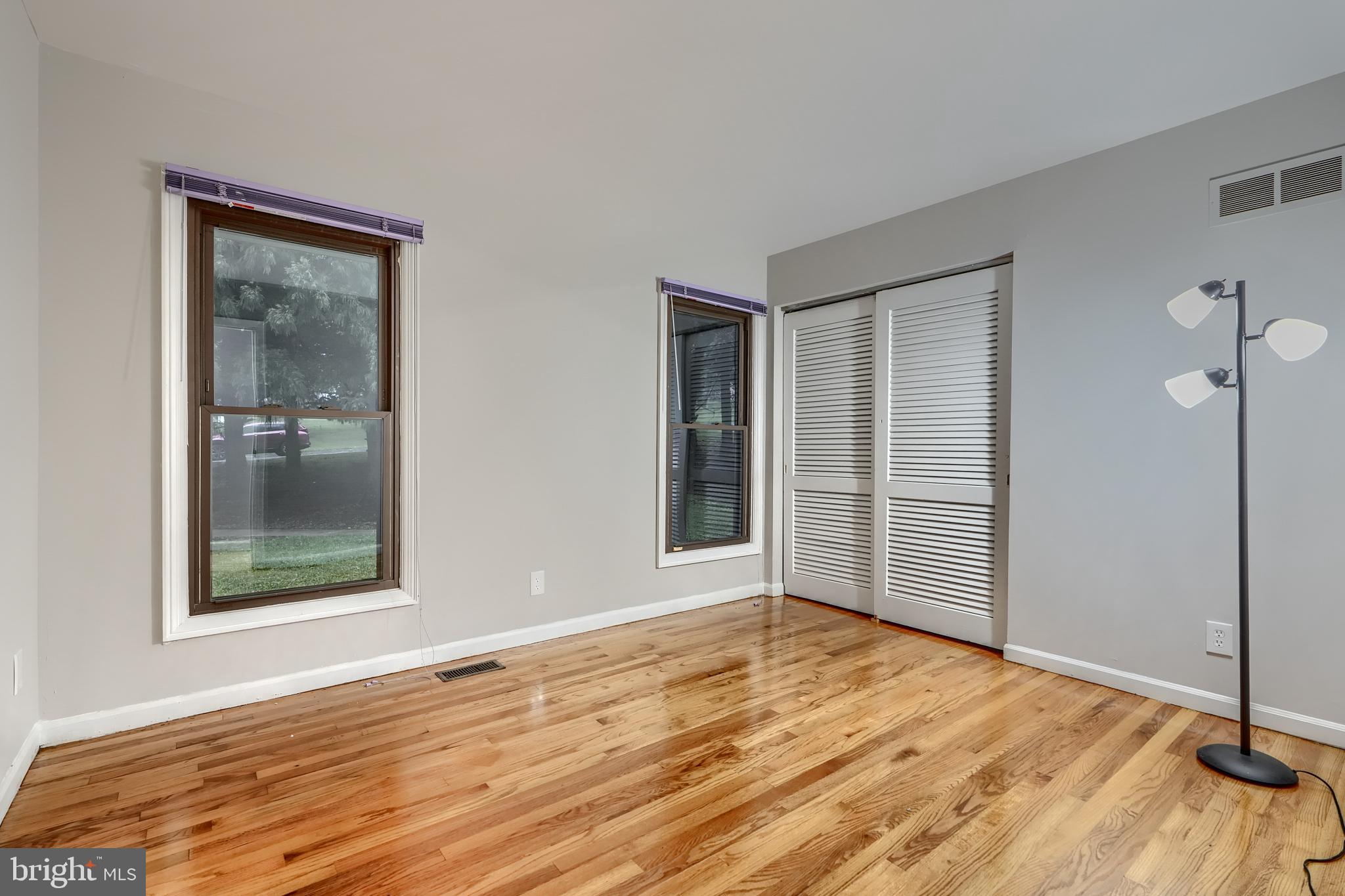1012 Valewood Road Towson, MD 21286 - Photo 23 of 48 an empty room with wooden floor and windows