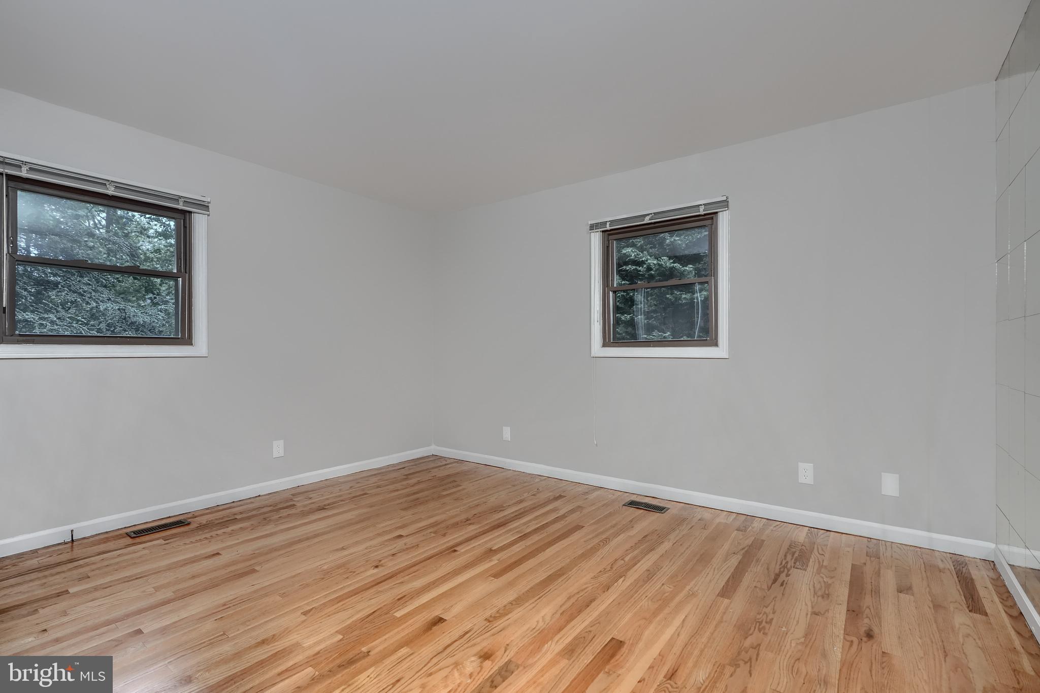 1012 Valewood Road Towson, MD 21286 - Photo 34 of 48 an empty room with wooden floor and windows