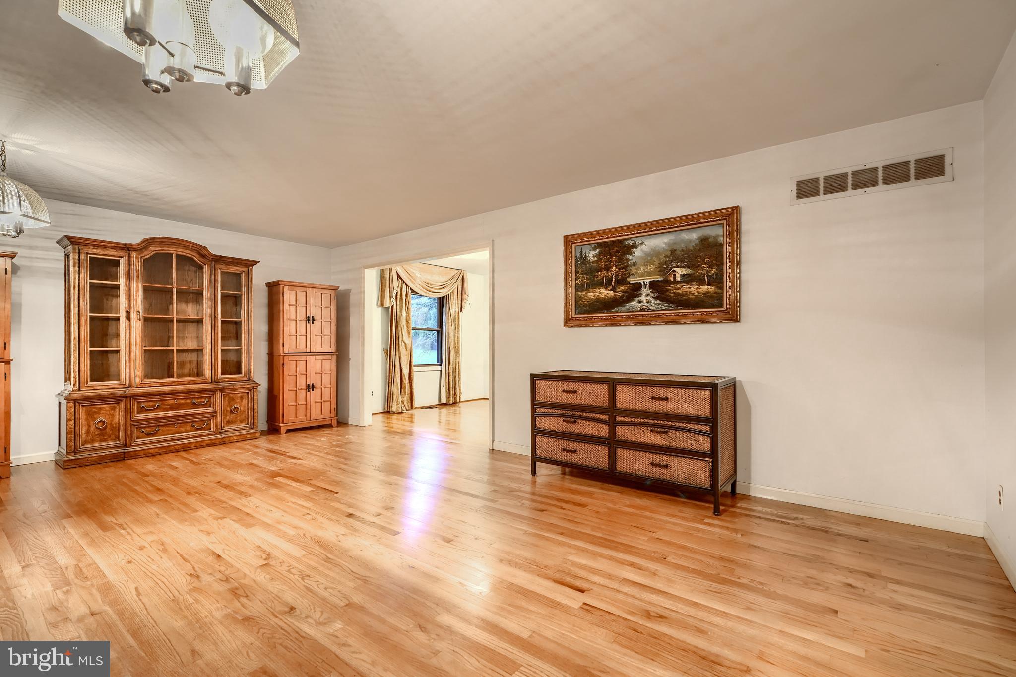 1012 Valewood Road Towson, MD 21286 - Photo 8 of 48 an empty room with wooden floor cabinet and windows