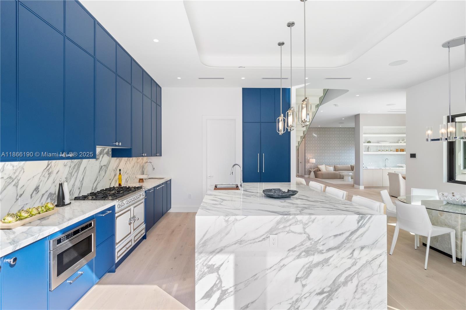 9132 Dickens Avenue Surfside, FL 33154 - Photo 11 of 37 a kitchen with granite countertop a sink stove and cabinets
