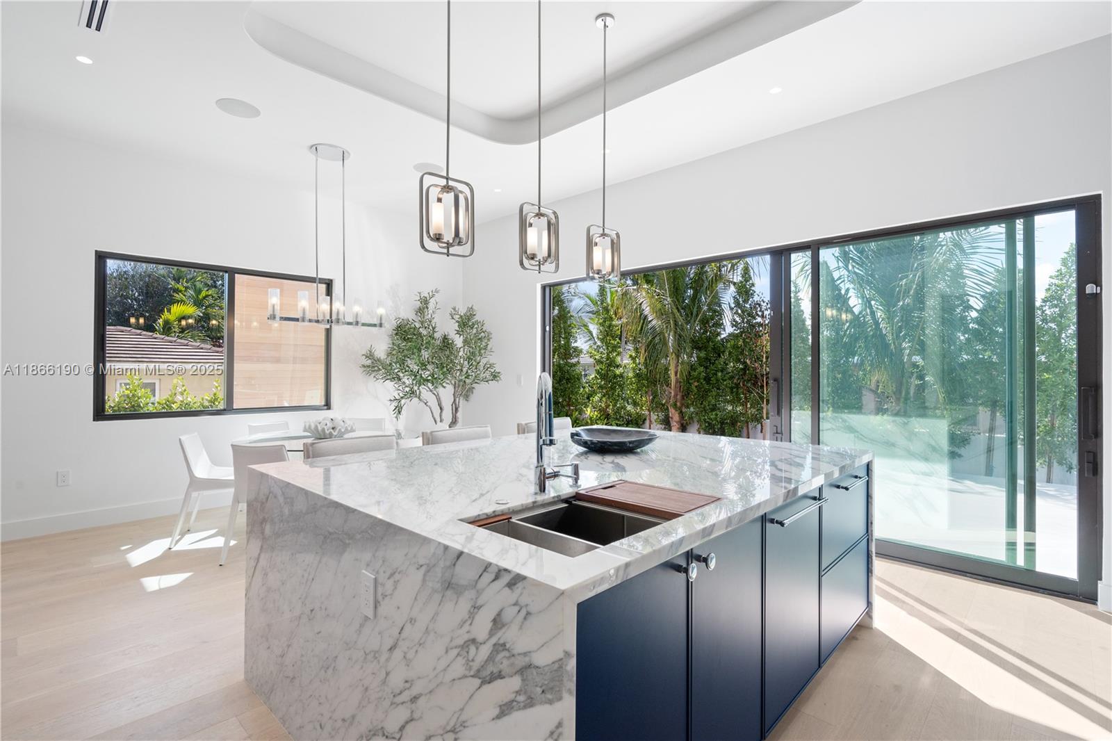 9132 Dickens Avenue Surfside, FL 33154 - Photo 12 of 37 a kitchen with stainless steel appliances a sink a counter top space and a view of living room